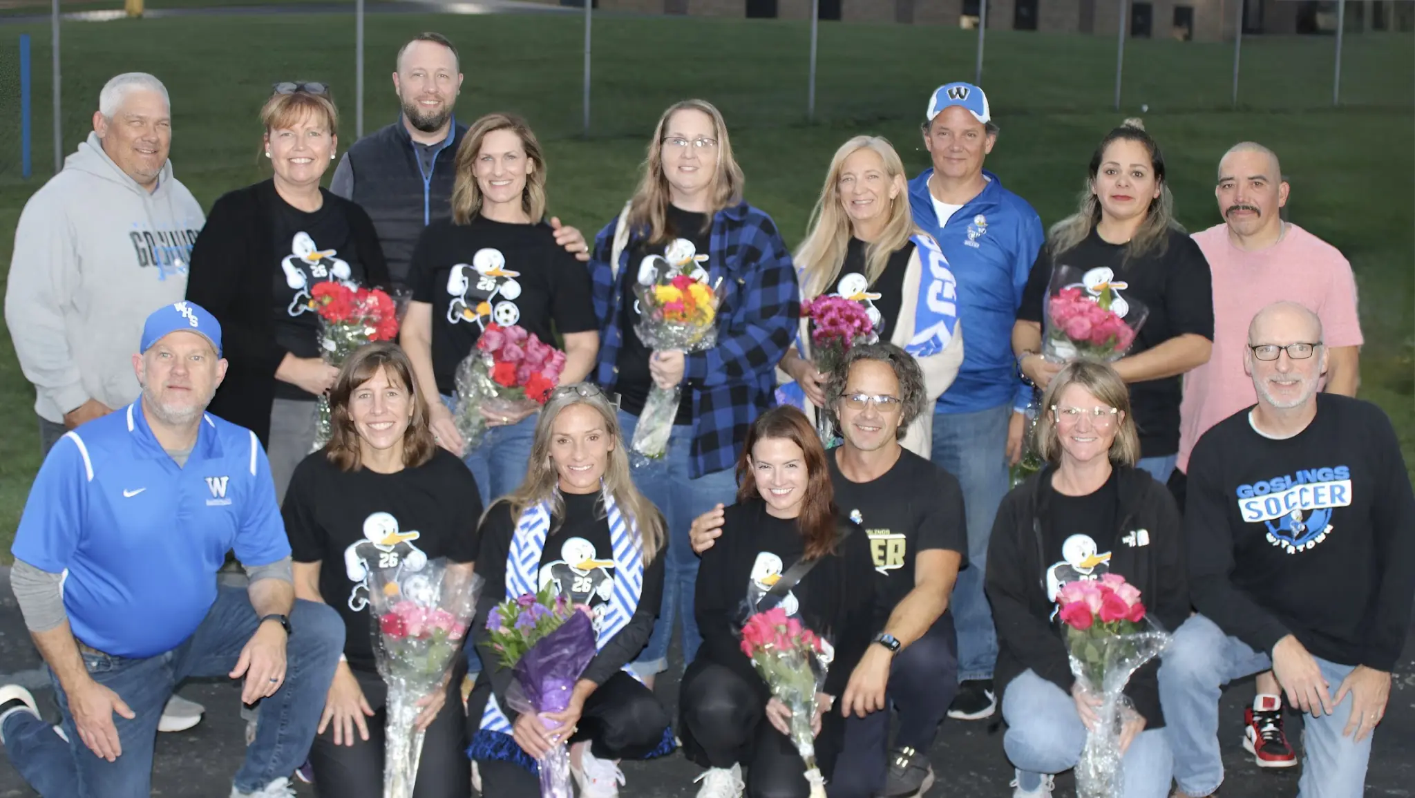 Senior-night families and supporters gathered for a group portrait