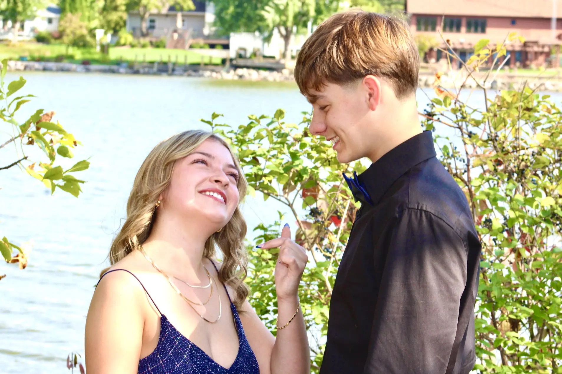 Young couple sharing a candid laugh beside the water